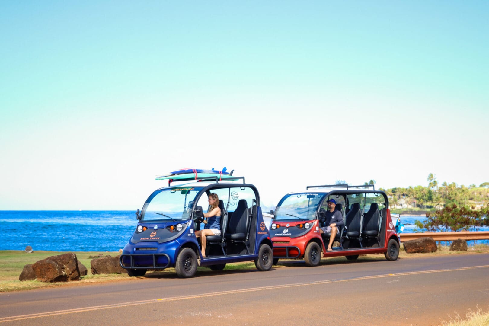 Two electric vehicles parked on the side of a road.