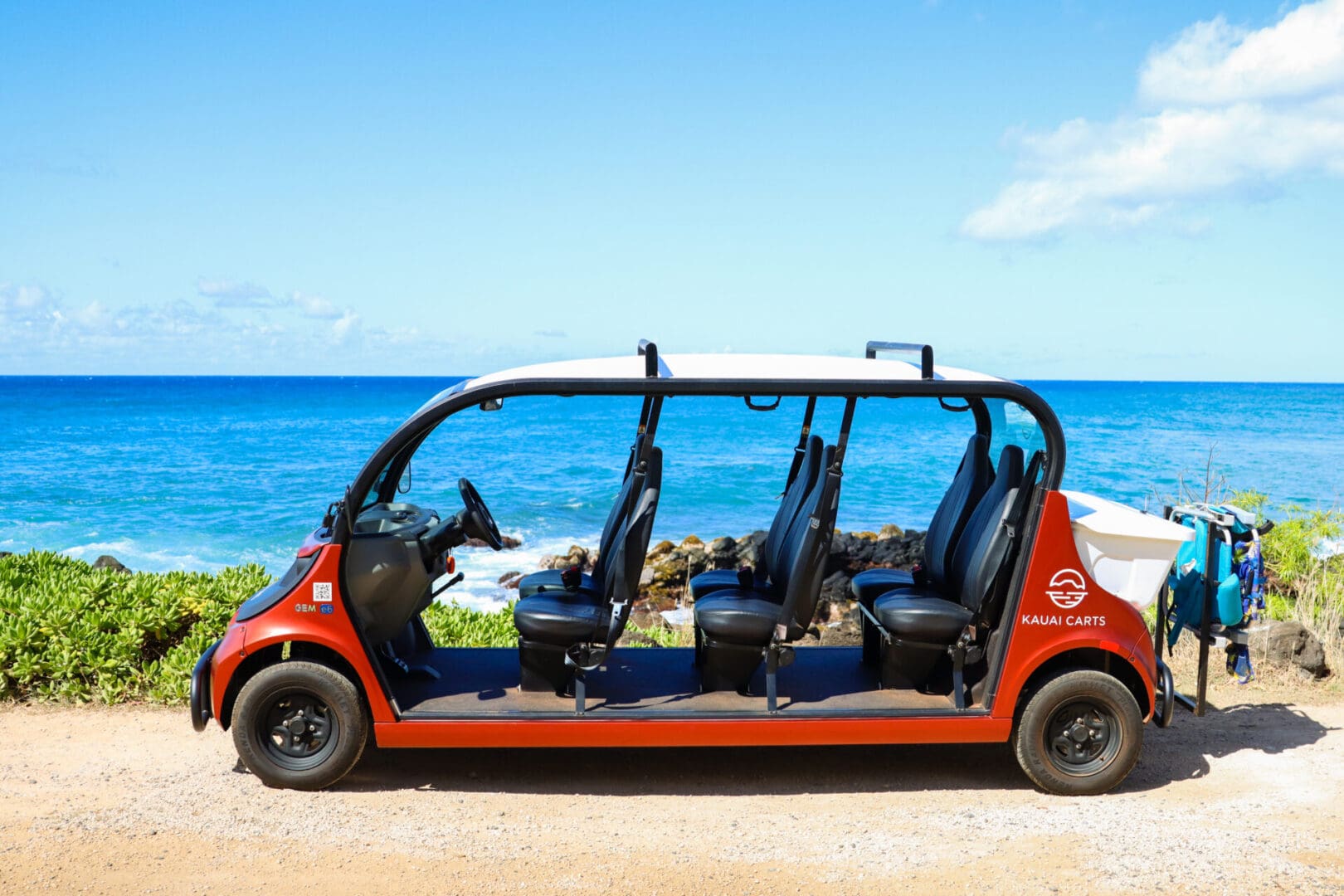 A red car with four seats on the side of it.