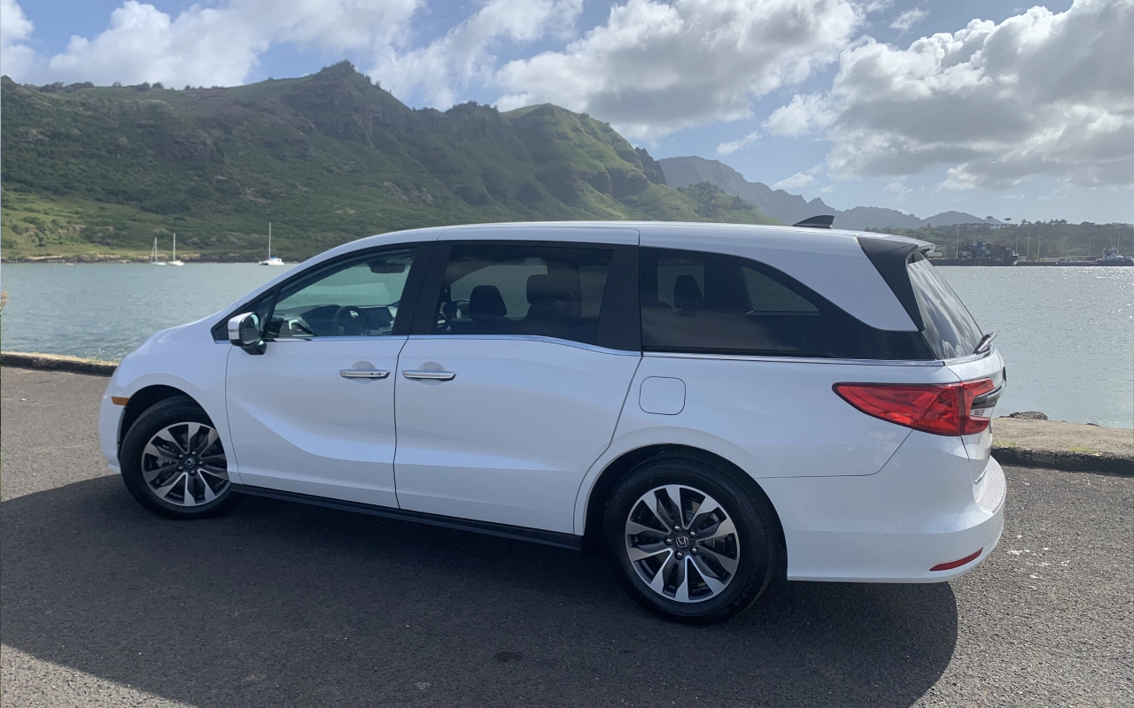 A white van is parked on the side of a road.