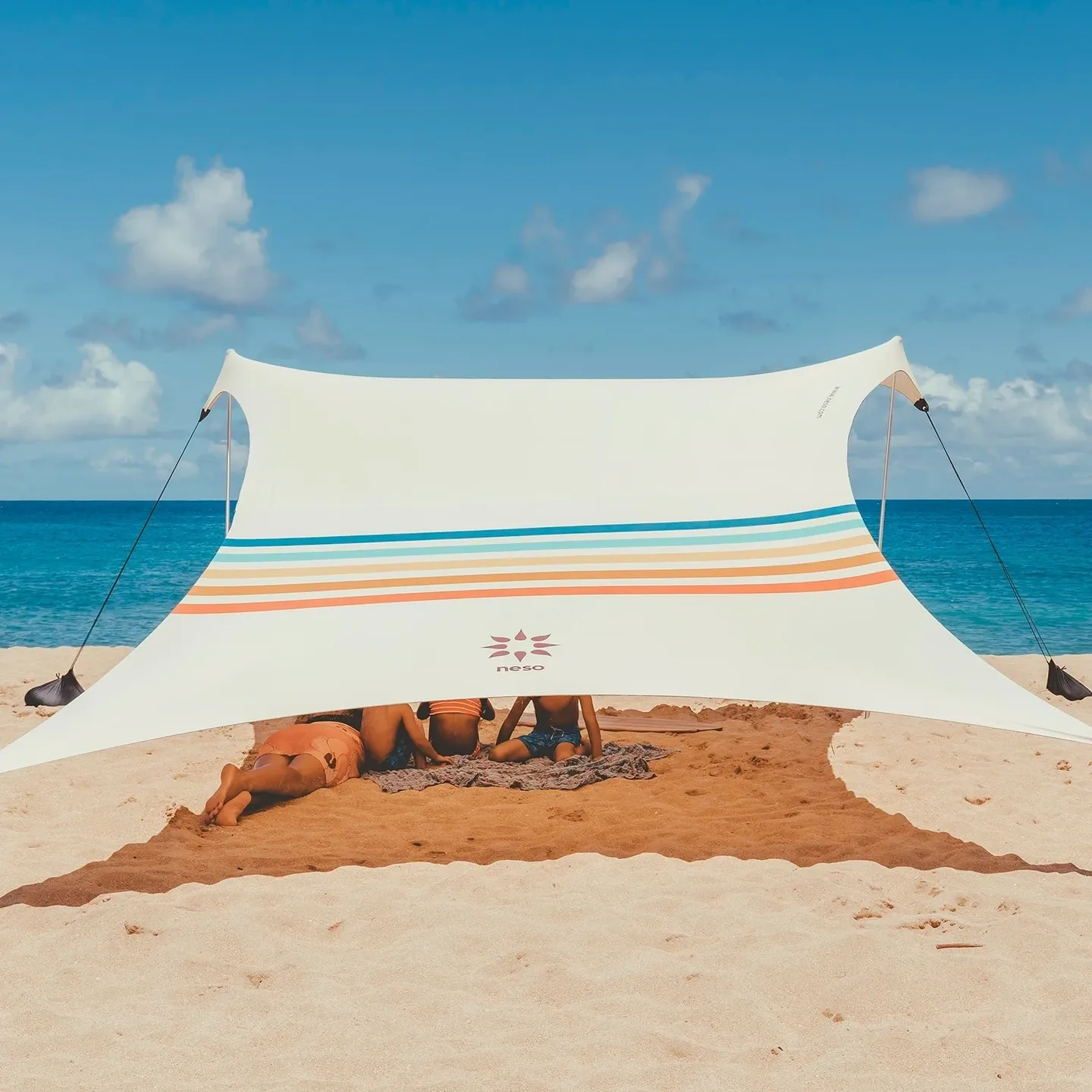 A beach with a large white sail on it