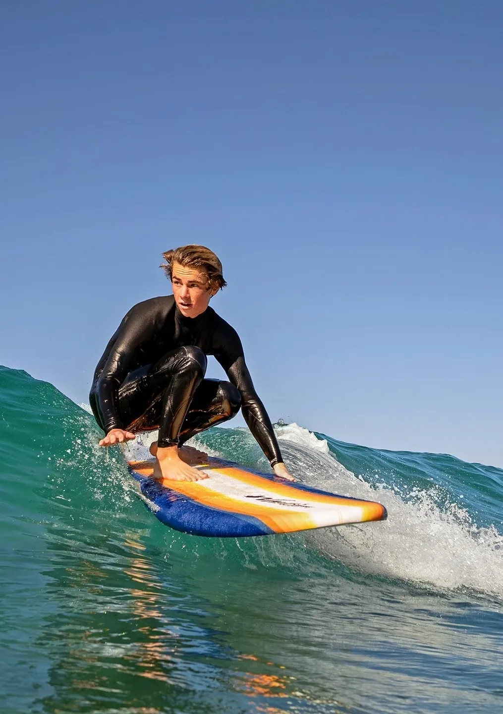 A man riding on top of a surfboard in the ocean.