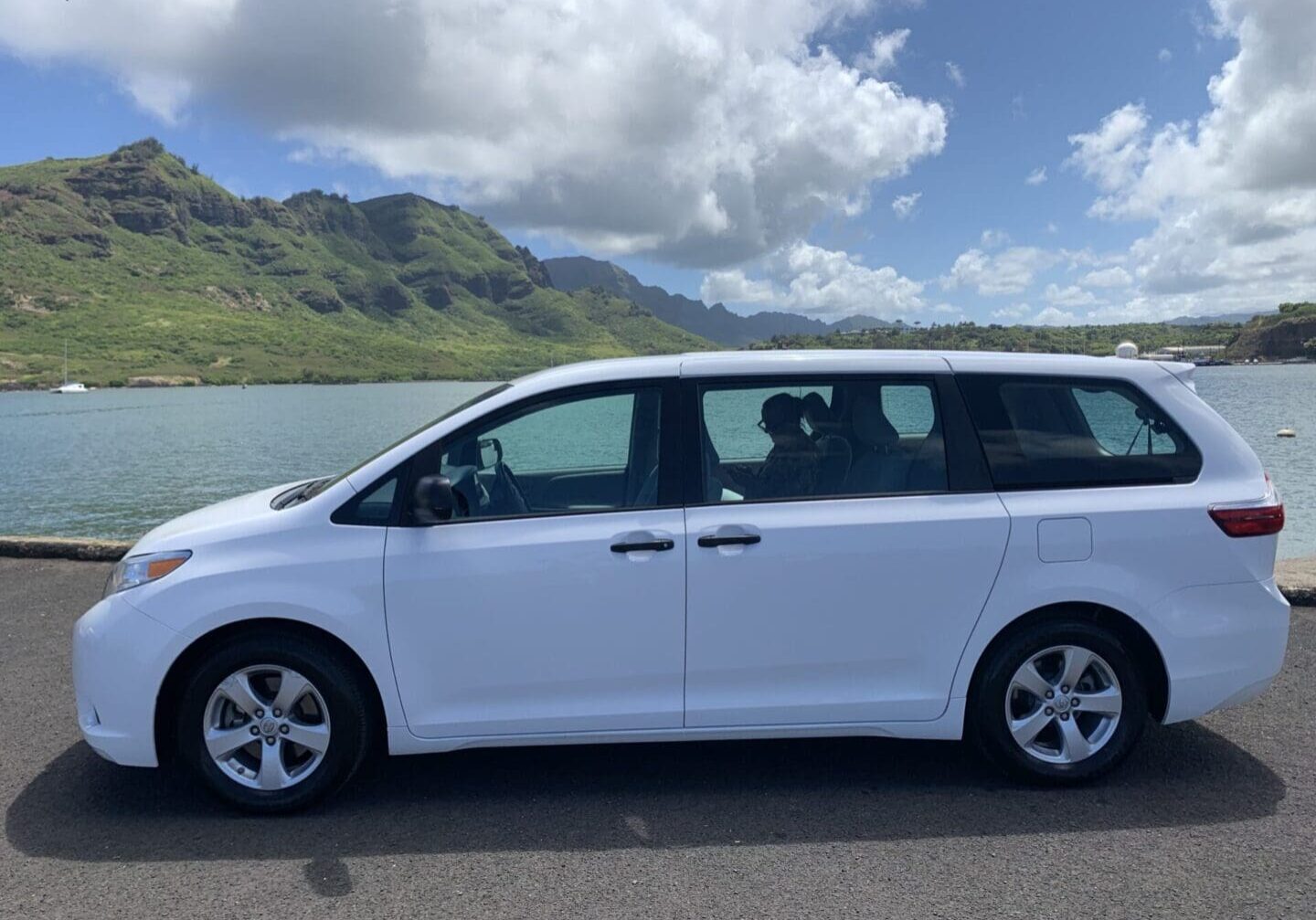 A white van parked on the side of a road.